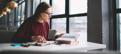 Image: A young woman studying at a library