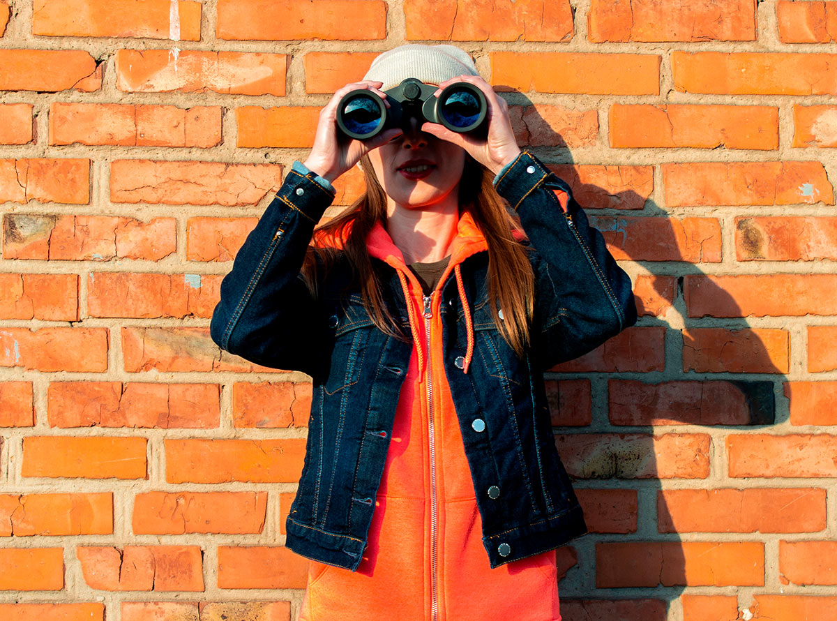 Young female student with binoculars