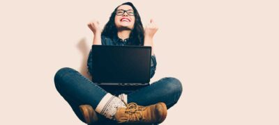 Very happy young woman with laptop